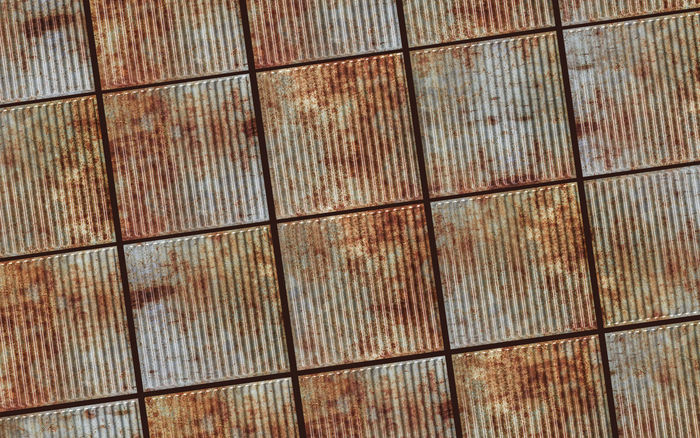 Old Tin Roof Ceiling Tile in a Ceiling Grid